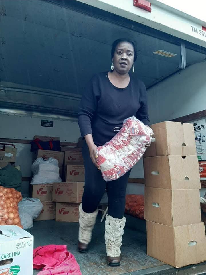 Volunteer handing out books